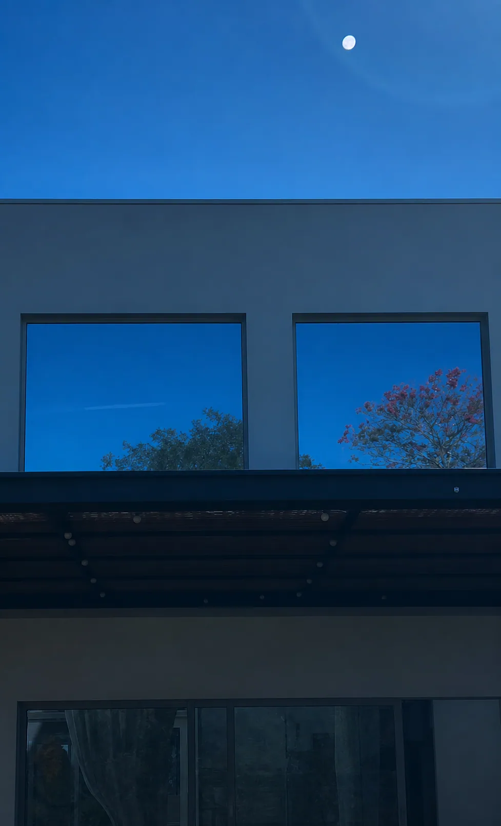Fachada residencial com película refletiva e efeito espelhado nos vidros